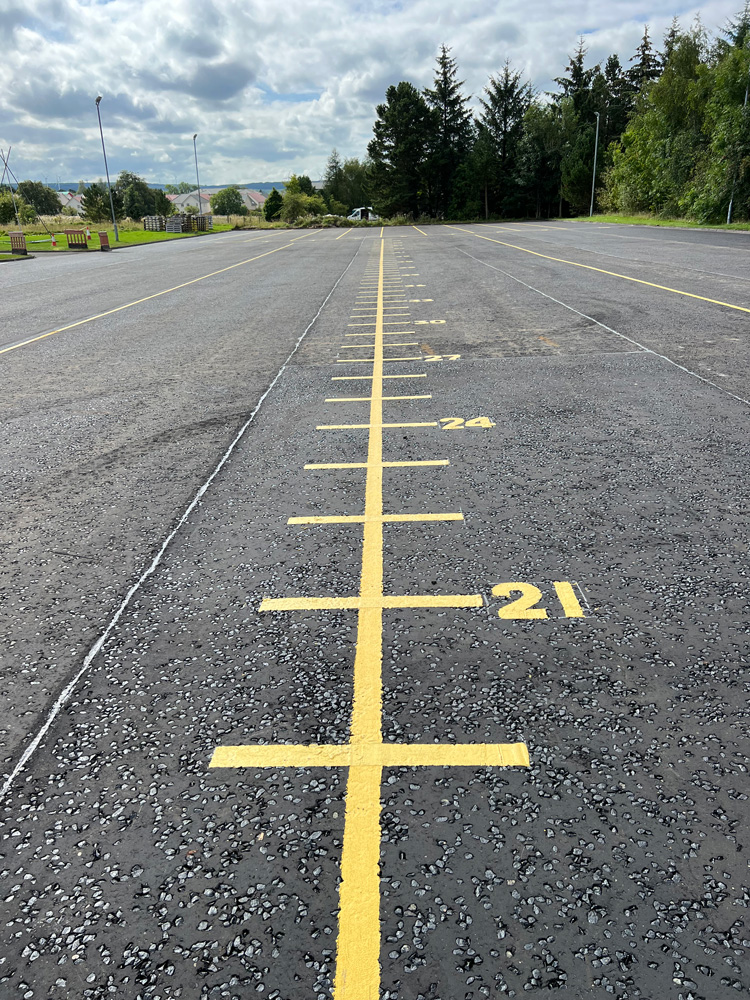 Numbered yellow markings on newly laid Tarmac 